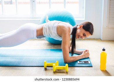 Ahtletic beautiful woman training at home - Young girl doing fitness in her apartment, concepts about fitness, sport and health