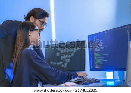 AI engineer developing algorithms in a futuristic data center. The blue light reflects innovation in machine learning, generative AI, blockchain, and modern cybersecurity.