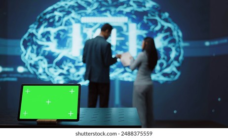 AI programmers colleagues using green screen laptop for business data analysis. IT experts in high tech location work on chroma key notebook to automatize tasks using artificial intelligence, camera B