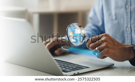 AI searching concept. artificial intelligence tool, Businessman holding a magnifying glass an AI icon and a Search engine bar on laptop. Data search optimization by artificial intelligence technology