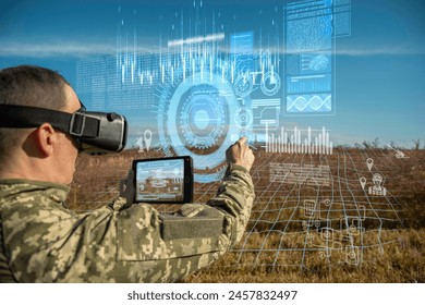 AI technology in the army. Warfare analytic operator using vr virtual reality glasses checking coordination of the military team with tablet device augmented reality operating troops outdoors - Powered by Shutterstock