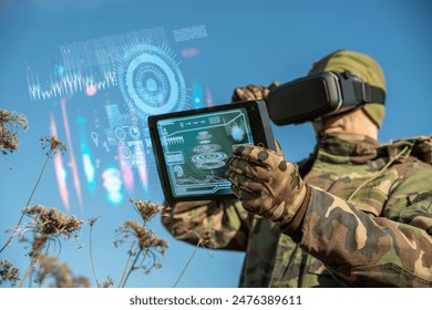 AI technology in the army. Warfare analytic operator using vr virtual reality glasses checking coordination of the military team with tablet device augmented reality operating troops outdoors - Powered by Shutterstock