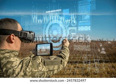 AI technology in the army. Warfare analytic operator using vr virtual reality glasses checking coordination of the military team with tablet device augmented reality operating troops outdoors