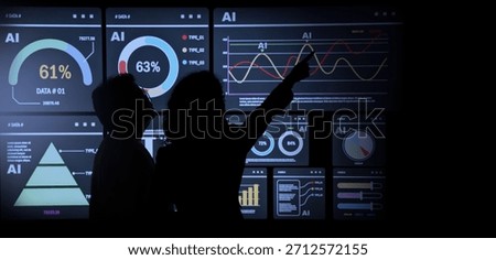 AI Using. Silhouetted analysts interact with a large AI data. AI Display charts graphs and analytics. Business team using futuristic AI interface visuals data. Technology with biz insight and big data