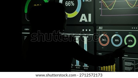 AI Using. Silhouetted analysts interact with a large AI data. AI Display charts graphs and analytics. Business team using futuristic AI interface visuals data. Technology with biz insight and big data