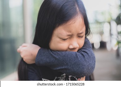 Aian Girl Covering Nose With His Arm, Child Having Allergy And Sneezing While Playing Around,Kid Scratching Nose, Children Has Reflection Or Hay Fever From Dusty,Allergies And Asthma Issues In Kid