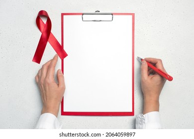 AIDS Red Ribbon On The Doctors Desk, White Background