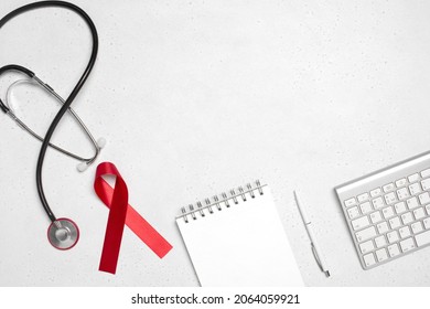 AIDS Red Ribbon On The Doctors Desk, White Background