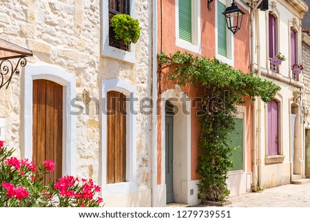     Aigues-Mortes in the south of France, typical colorful houses in the village 