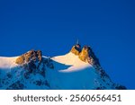 Aiguille du Midi peak in the Alps. Chamonix valley landscape of a prominent rocky towering mountain peak in French Alps. Chamonix-Montblanc area beautiful landscape of Aiguille du Midi summit, France