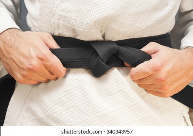 Aikido black belt on white kimono - Shutterstock ID 340343957