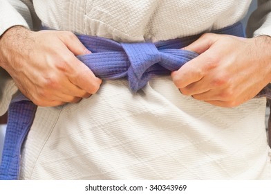 Aikido blue belt on white kimono - Shutterstock ID 340343969