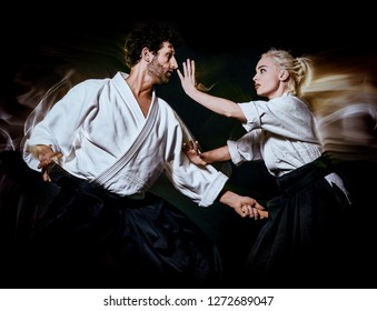 Aikido bodokas man and woman isolated black background