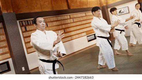 Aikido dojo, students and fight for martial arts, strike or together for combat at training, gym or class. Japanese people, group and sport for exercise, workout or fitness with zen, conflict or club - Powered by Shutterstock