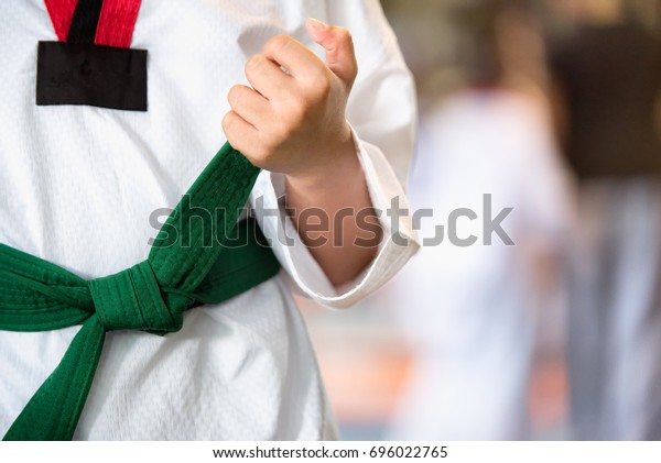 Aikido green belt. TTaekwondo kids athletes. Moment\
of athlete to warm up and strike an opponent during the tournament\
taekwondo kids