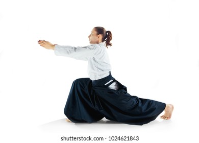 Aikido master practices defense posture. Healthy lifestyle and sports concept. Woman in white kimono on white background. Karate woman with concentrated face in uniform.