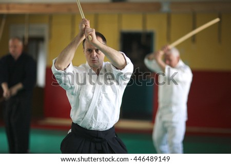 Aikido practitioner swinging the sword