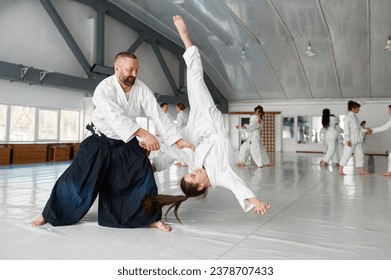 Aikido teacher and student training throwing and falling - Powered by Shutterstock