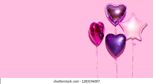 Air Balloons. Bunch Of Colorful Purple, Pink, Blue Heart Shaped Foil Balloons On Pink Background. Love. Holiday Celebration. Valentine's Day Party Decoration. Birthday. Metallic Balloon. Wide Screen