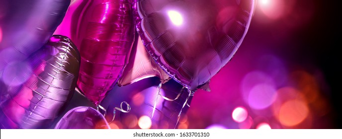 Air Balloons. Bunch Of Purple Heart Shaped Foil Balloons Art Design Holiday Background. Love. Celebration. Valentine's Day Purple, Red, Pink, Blue Backdrop. Party Decoration. Metallic Balloon Birthday