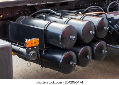 Air brake system of the truck. Black receivers with compressed air. Parts of a truck close-up - a few tanks with compressed air