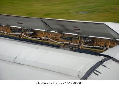 Air brakes and flaps on an aircraft wing as it slows after landing