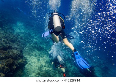 Air Bubbles Emerging From Diver At Coral Reef Under Water