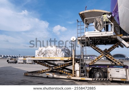 Air cargo logistic containers are loading to an airplane. Air transport shipment prepare for loading to modern freighter jet aircraft at the airport.
