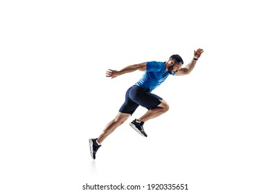 In air. Caucasian professional male athlete, runner training isolated on white studio background. Muscular, sportive man. Concept of action, motion, youth, healthy lifestyle. Copyspace for ad. - Shutterstock ID 1920335651