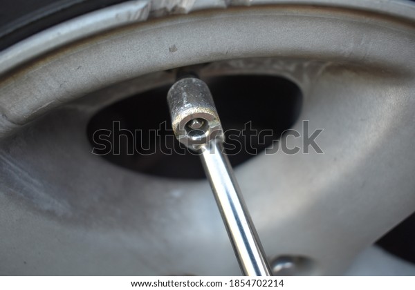 Air chuck on an air valve\
of a tire