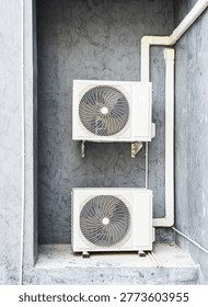 Air compressor cold temperature on wall grey cement building outdoor construction, electric fan power supply technology