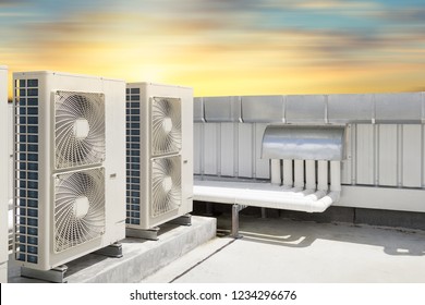 Air compressor or air condenser unit located on roof deck building to heat released transferred to surrounding environment, Compressor is part of cooling function and air conditioning HVAC systems.
