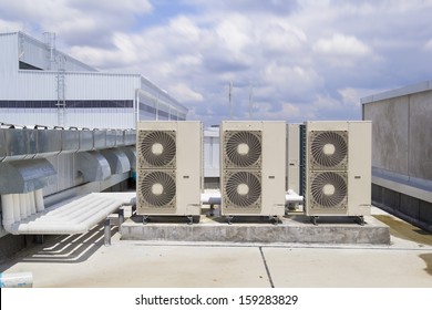 Air Compressor Or Air Condenser Unit Located On Roof Deck Building To Heat Released Transferred To The Surrounding Environment, Compressor Is Part Of Cooling Function And Air Conditioning HVAC System.