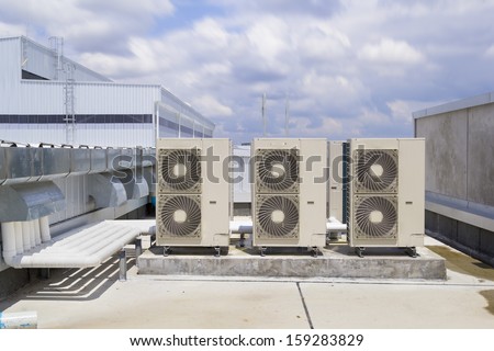 Air compressor or air condenser unit located on roof deck building to heat released transferred to the surrounding environment, Compressor is part of cooling function and air conditioning HVAC system.