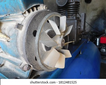 Air compressor, electric AC motor and air storage tank. Cooling Fan of a motor or generator without protective cover grill for safety. - Shutterstock ID 1812481525