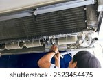 Air- con technician repairing or fixing air conditioner