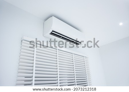 Air conditioner (ac) wall mount or indoor unit of split system for control climate, temperature and humidity. Include adjusting vertical or venetian blinds for adjust natural light to inside room. 商業照片 © 