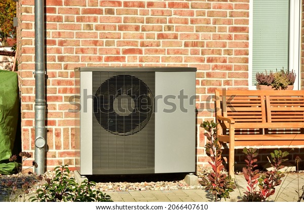 Air conditioner, Air-Air Heat\
Pump for Heating and hot Water in Front of an Residential\
Building