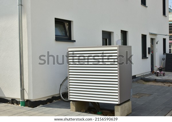 Air conditioner, Air-Air Heat\
Pump for Heating and hot Water in Front of an Residential\
Building