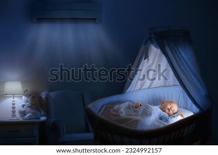 Air conditioner in baby bedroom. Kids room climate control. Infant child in crib under cool air breeze. Comfortable temperature, healthy sleep on summer night. Air conditioning device in family home.