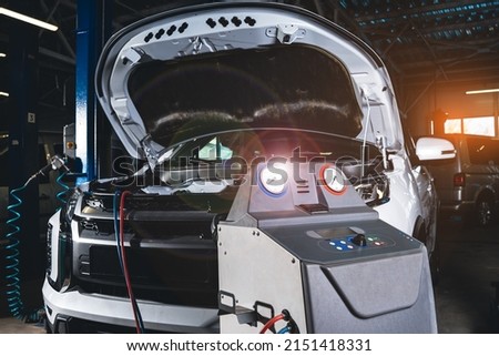 Air conditioner or climate control servicing. Diagnostics and refueling of the air-conditioning system using modern equipment. Professional auto service station.