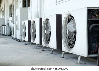 Air conditioner compressor installed in old building - Shutterstock ID 352983299