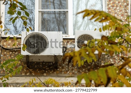 air conditioner, condenser unit, compressor on facade of building. unit of central AC conditioner of HVAC heating ventilation system. Indoor and office air cooling during seasonal temperature rise.