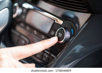 Air Conditioner Control Panel, Car Cooling System. Finger Presses The AC Knob