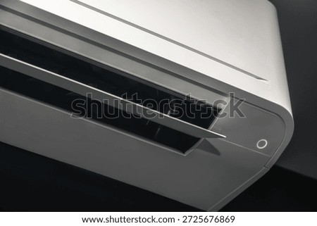 Air conditioner cooling system operating in dark bedroom. Wall mounted AC appliance swing blade working for comfortable sleep.