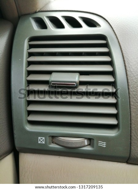 Air conditioner mask in car, close up\
plastic mask and button for adjust air\
flow.