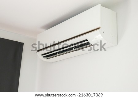 Air conditioner on white wall room interior background