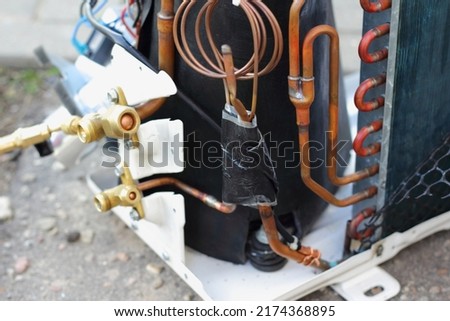 Air conditioner outdoor wall unit inside pipes and radiator repair closeup view