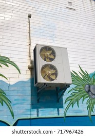 An air conditioner outer unit on a wall.