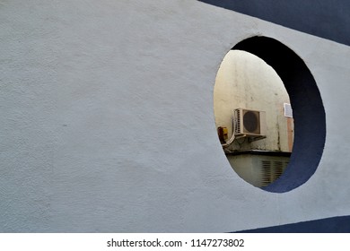 Air Conditioner In The Round Hole In The Wall